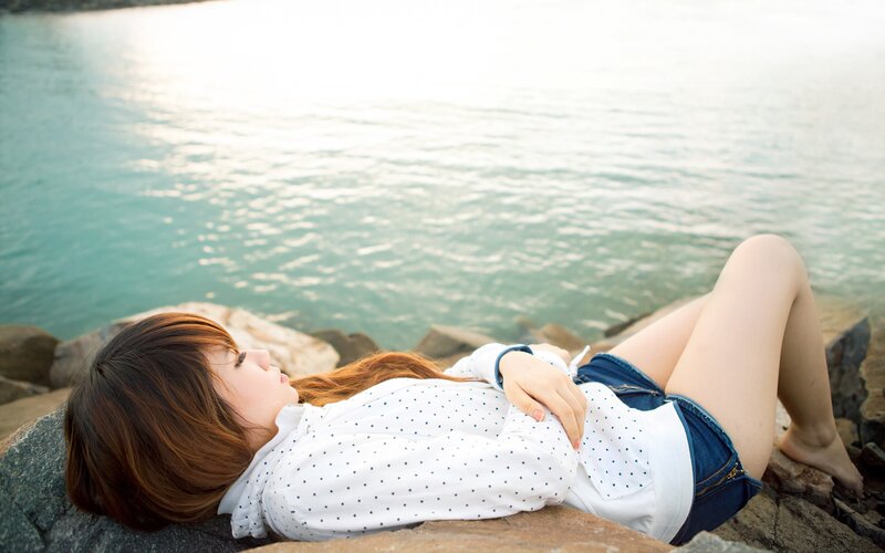 Woman resting by the sea