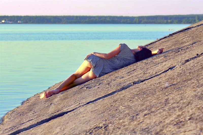 Woman resting by the water