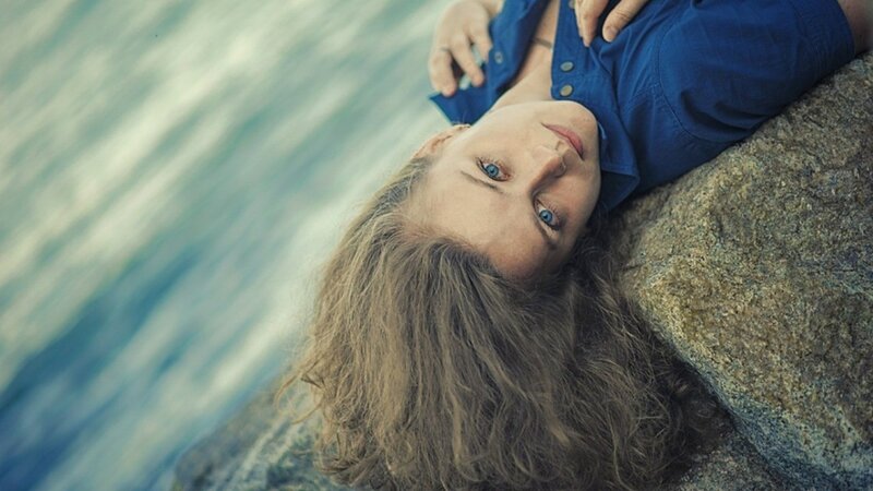 woman resting by the water