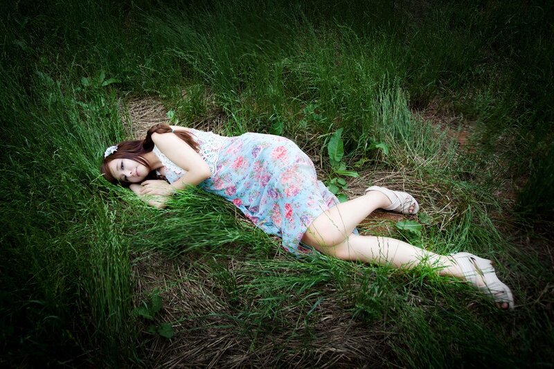 Woman resting in a grassy field