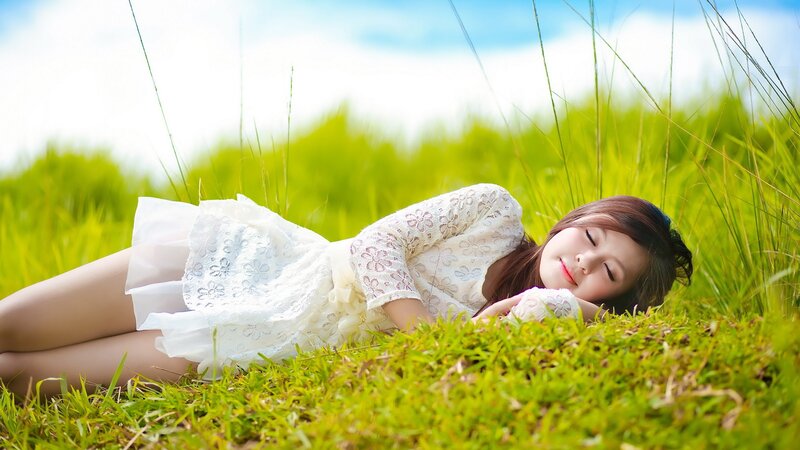Woman resting in a grassy field