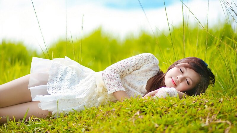 Woman resting in a grassy field