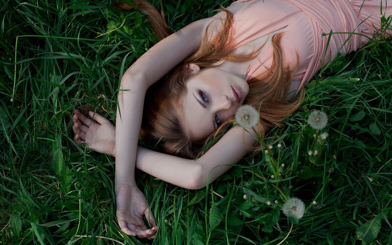 Woman resting in a grassy field