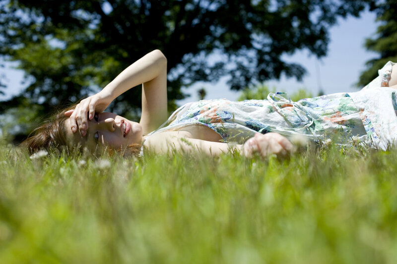 Woman resting in a grassy field