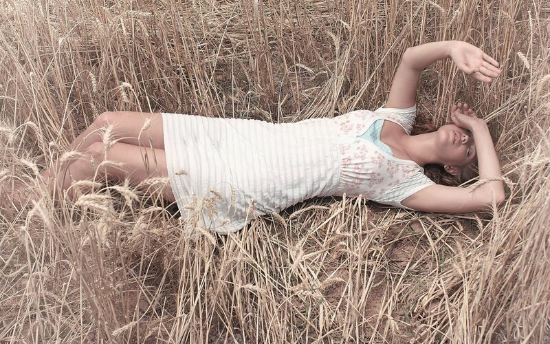 Woman resting in a wheat field