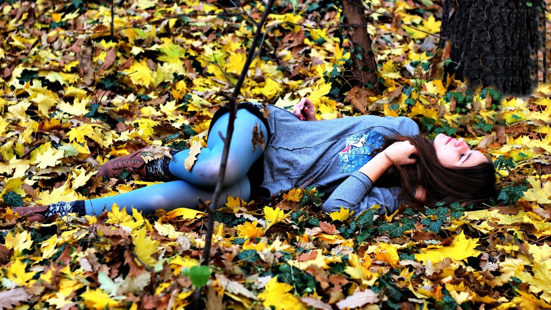 Woman resting in autumn leaves