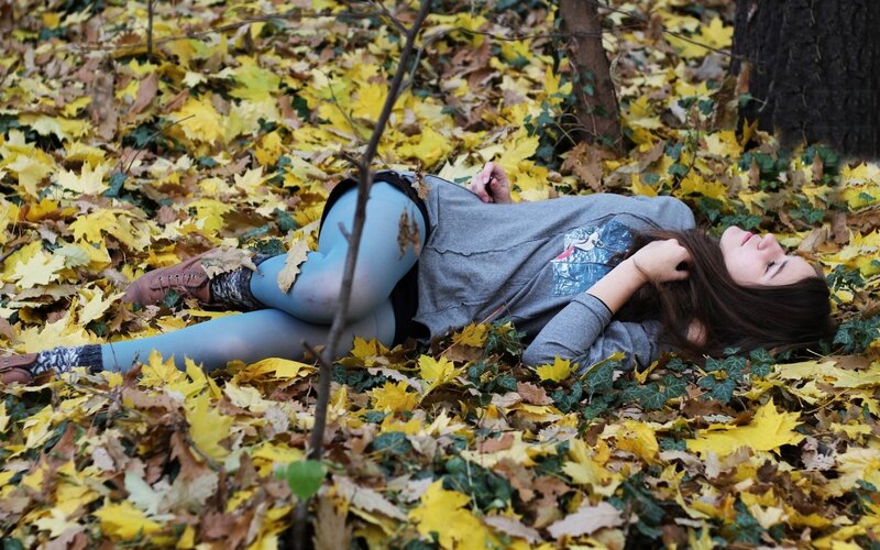 Woman resting in autumn leaves