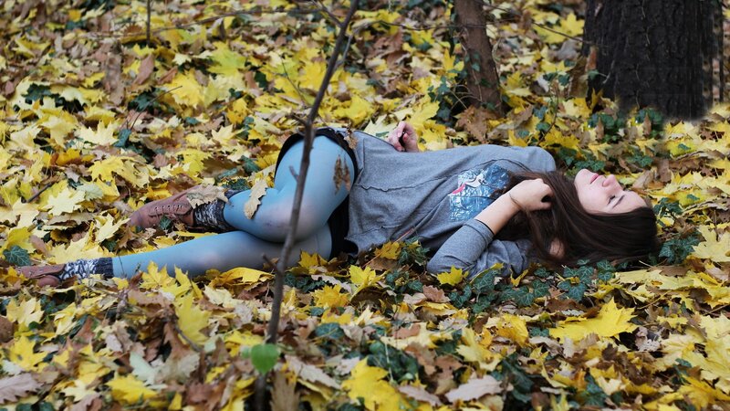 Woman resting in autumn leaves