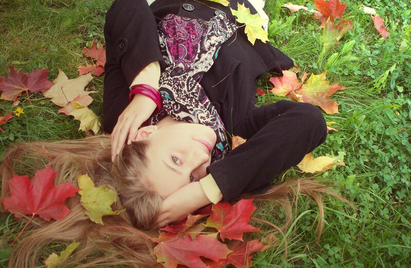 woman resting in autumn leaves
