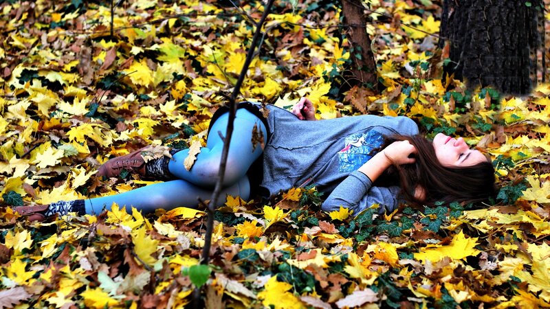 Woman resting in autumn leaves