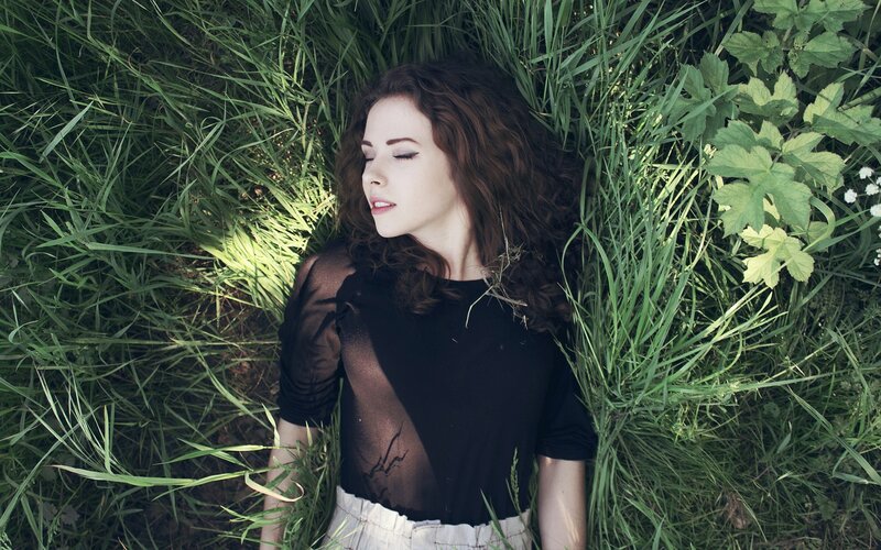 woman resting in grass