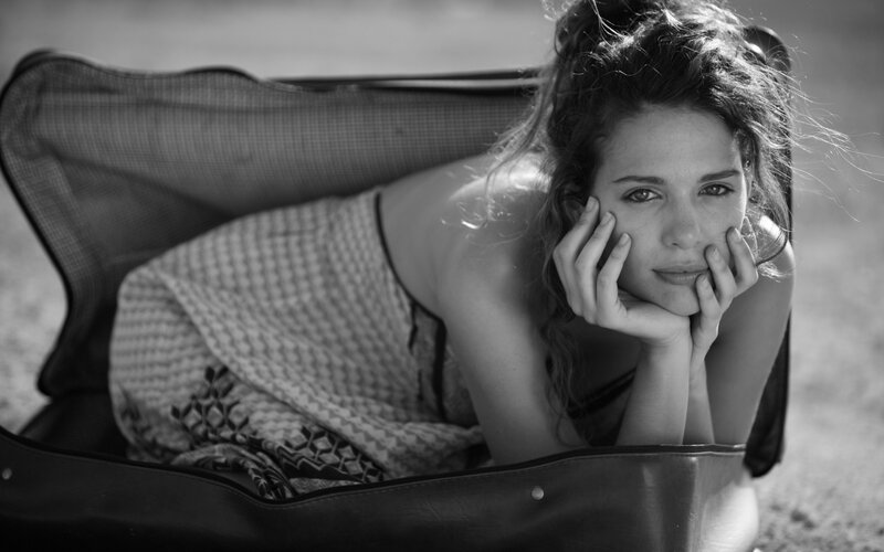 woman resting in suitcase