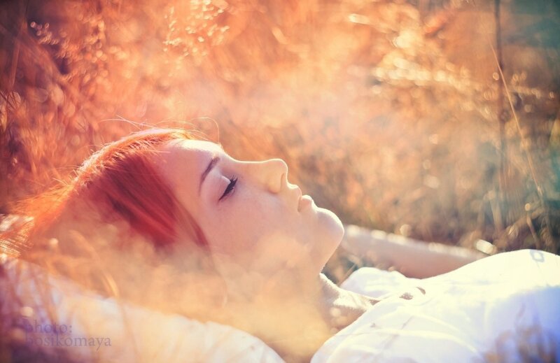 woman resting in sunlit field