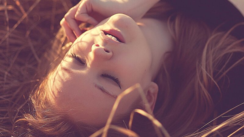 woman resting in sunlit grass