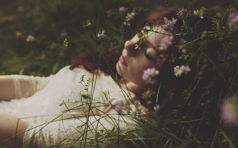 woman resting in wildflowers