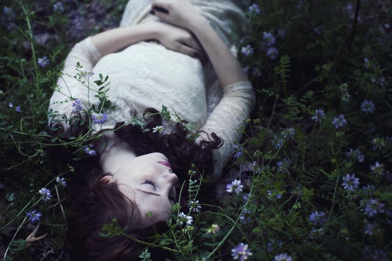 woman resting in wildflowers