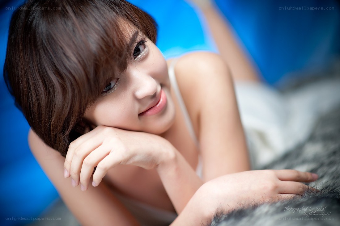 woman resting on a bed