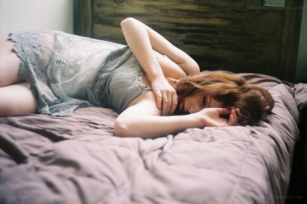 woman resting on a bed