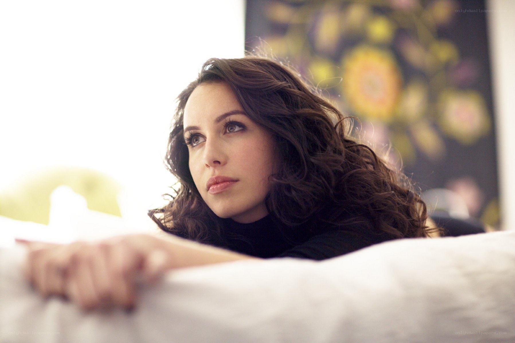 woman resting on a bed