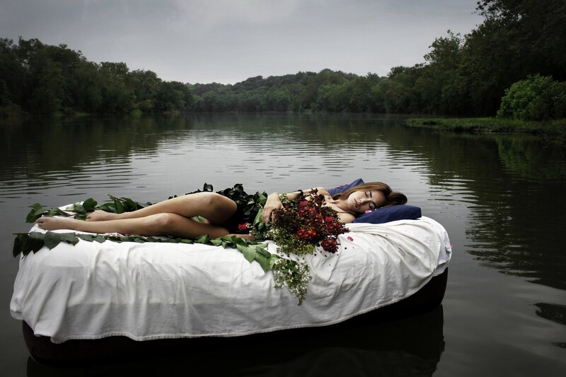 Woman resting on a bed in water