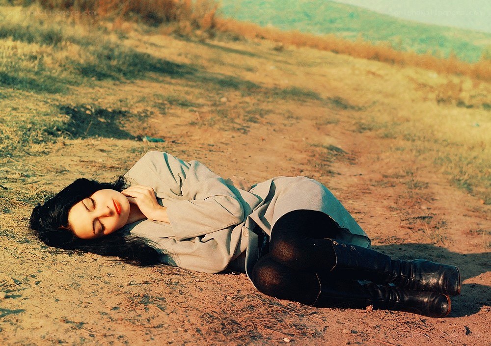 Woman resting on a dirt path