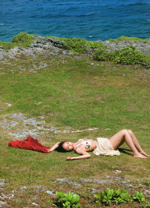 Woman resting on a grassy cliff