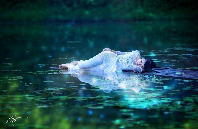 Woman resting on a lily pad