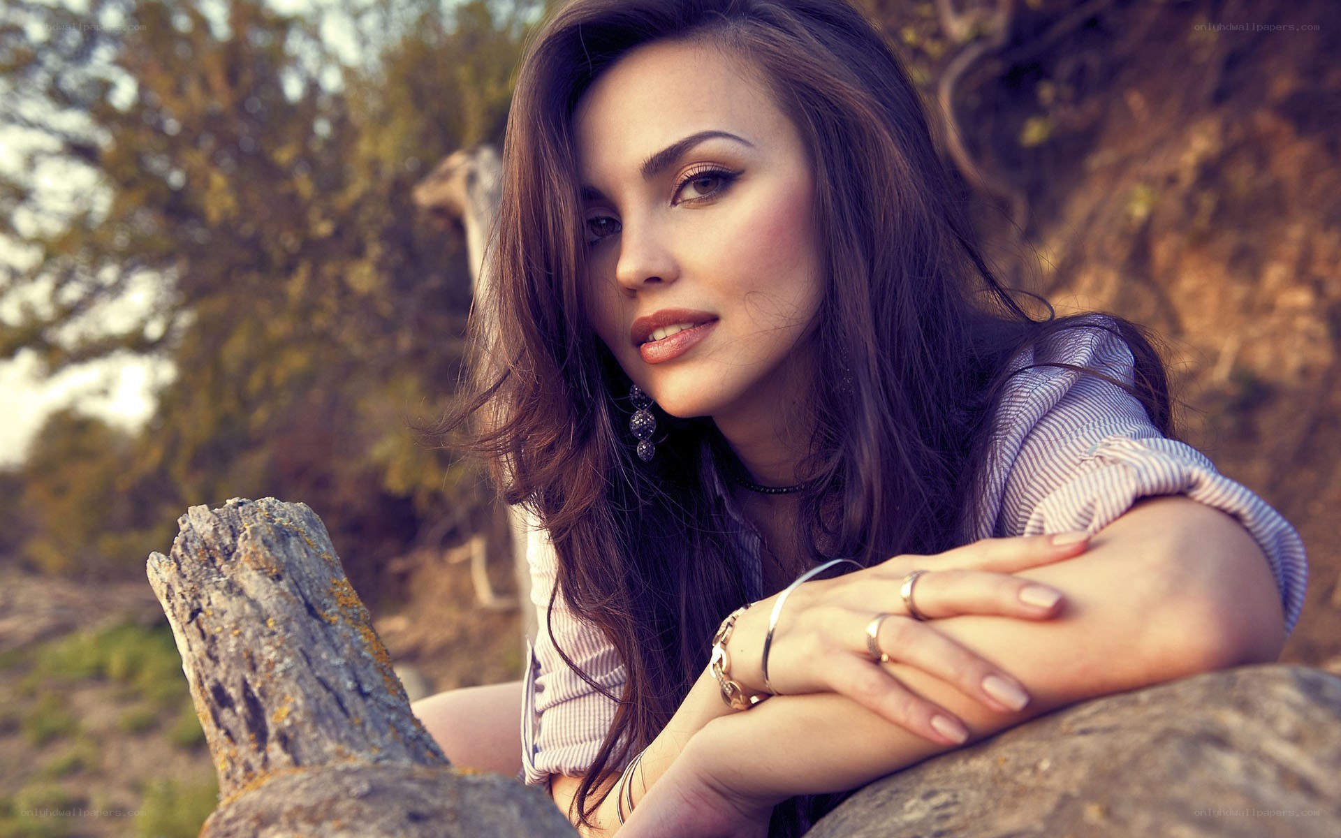 woman resting on a log