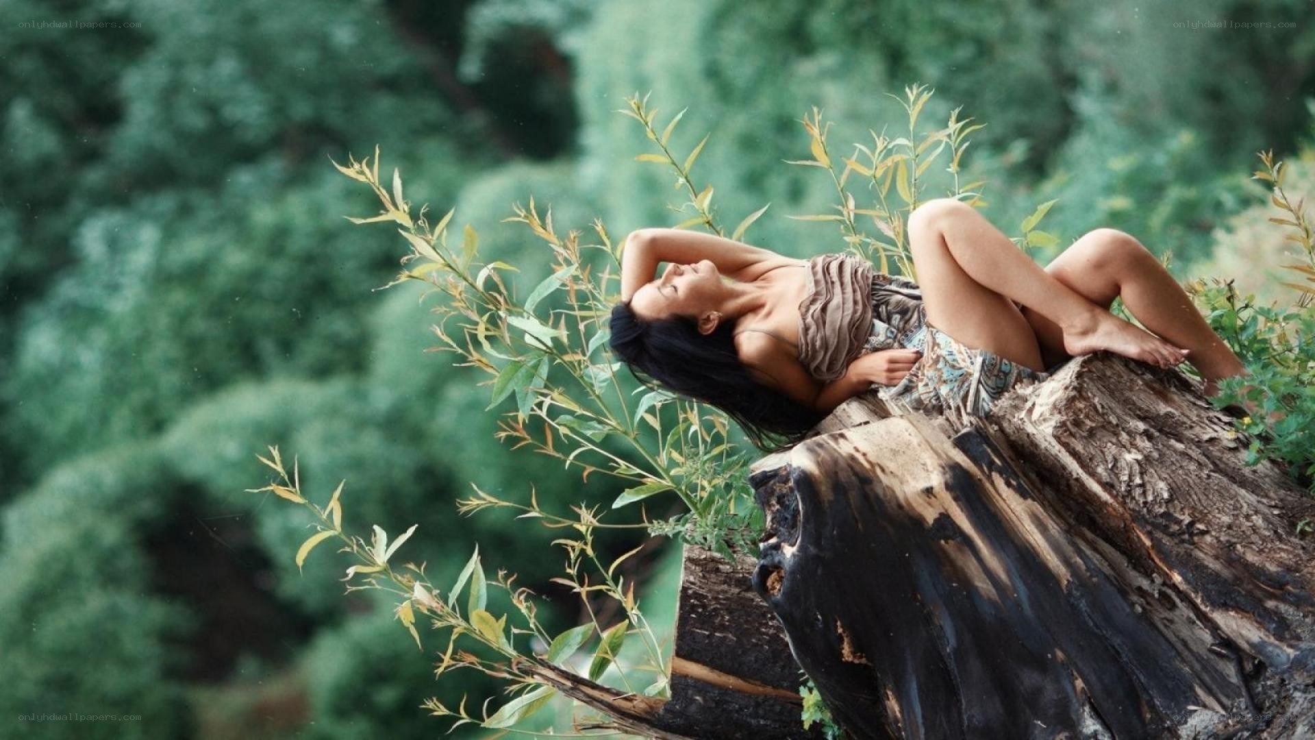Woman resting on a log