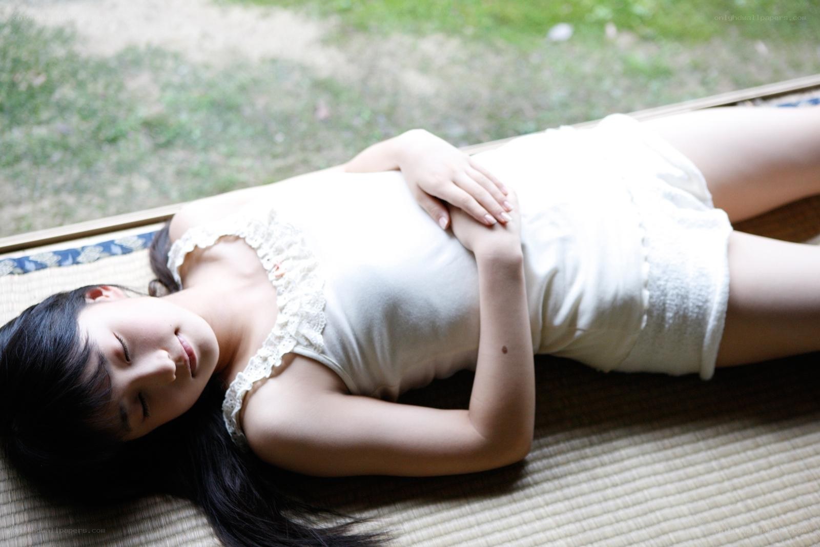 woman resting on a mat