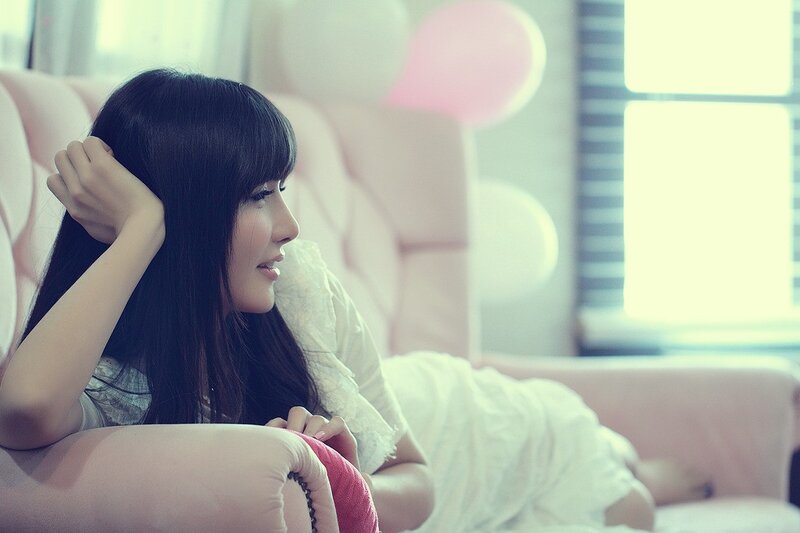 woman resting on a pink couch