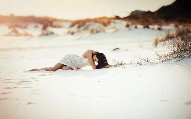 Woman resting on a sandy beach