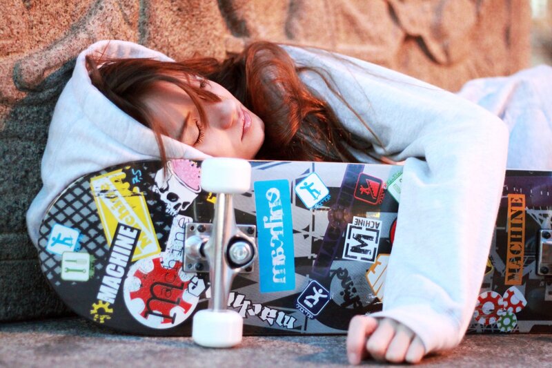 Woman resting on a skateboard
