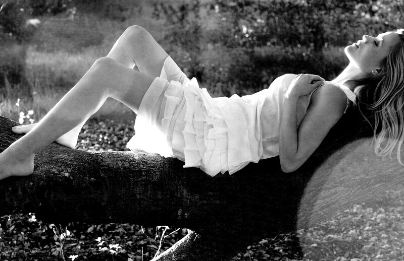 Woman resting on a tree branch