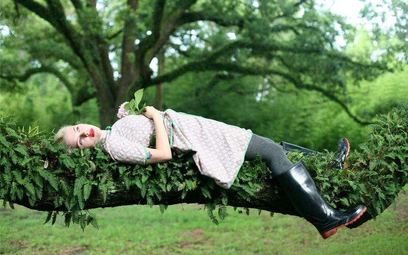 Woman resting on a tree branch