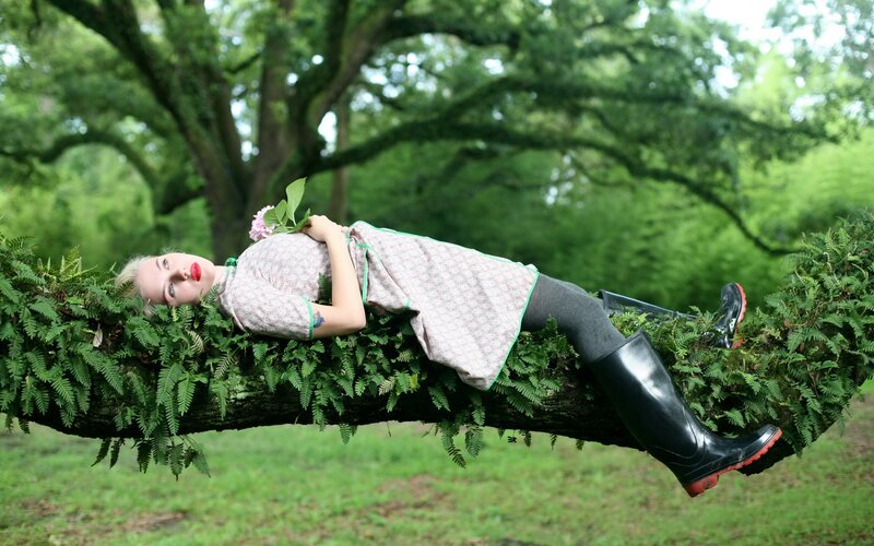 Woman resting on a tree branch