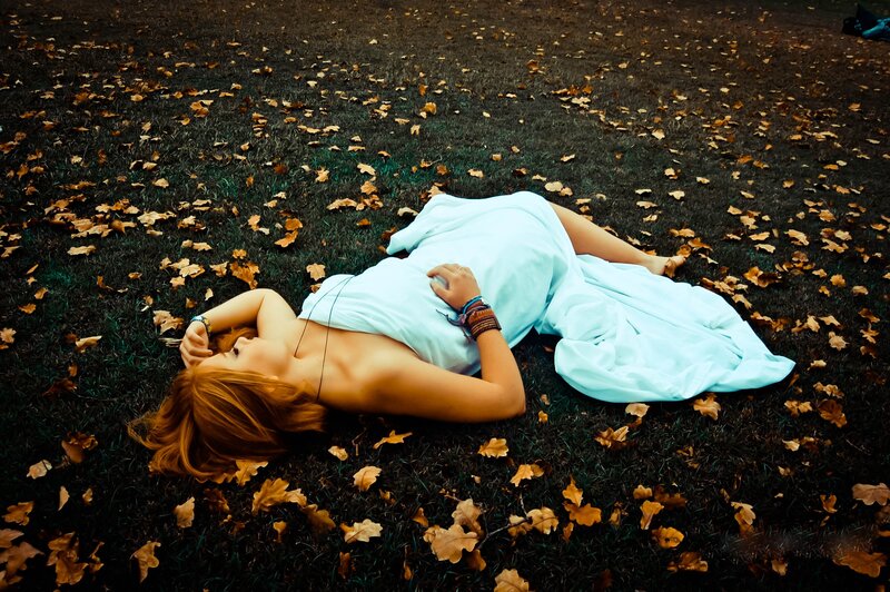 Woman resting on autumn grass