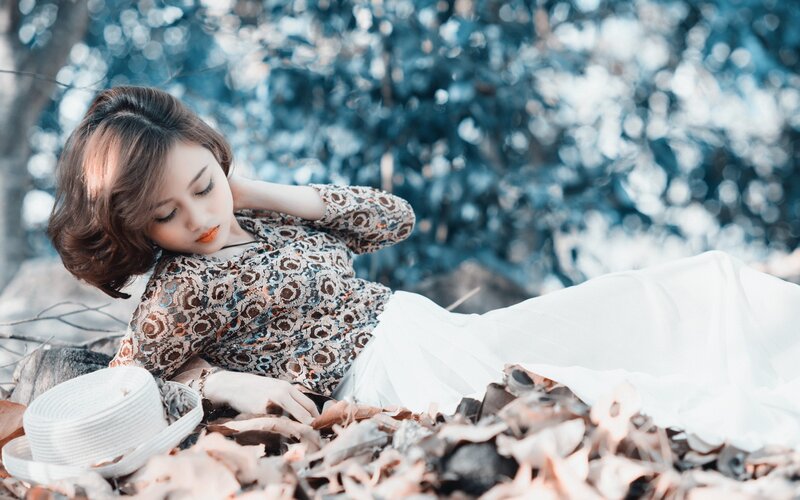 Woman resting on autumn leaves