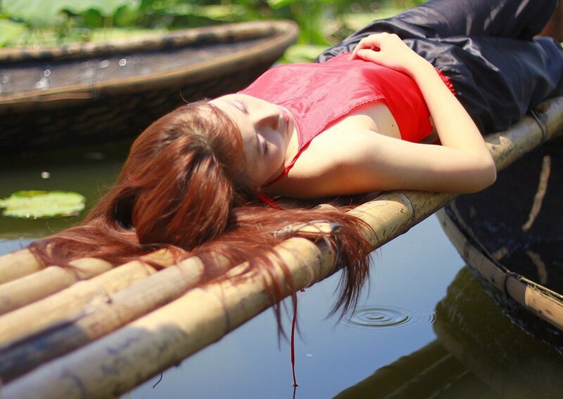 Woman resting on bamboo raft