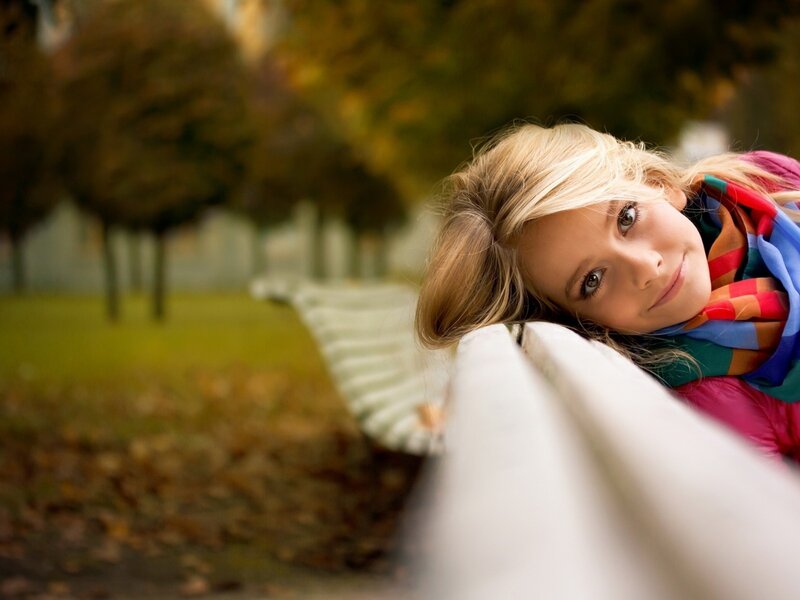 woman resting on bench in park