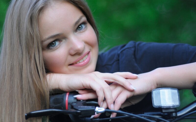 woman resting on bicycle