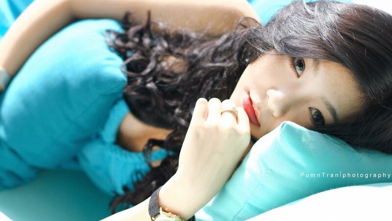 woman resting on blue pillow