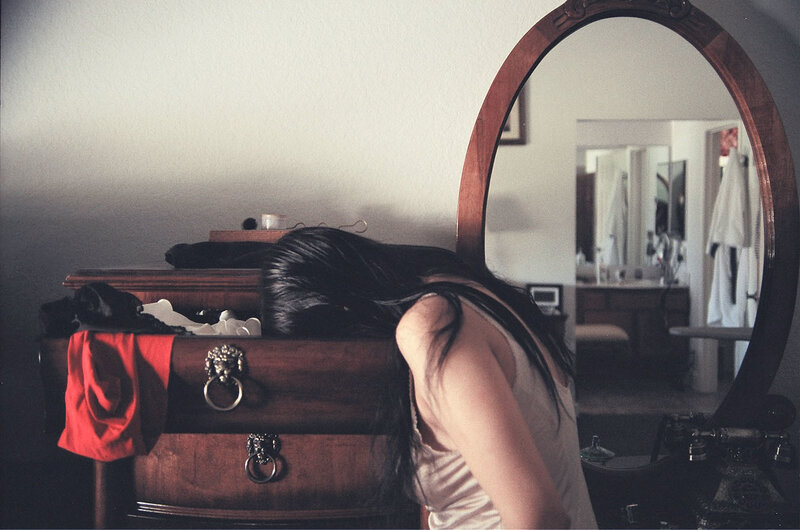 woman resting on dresser
