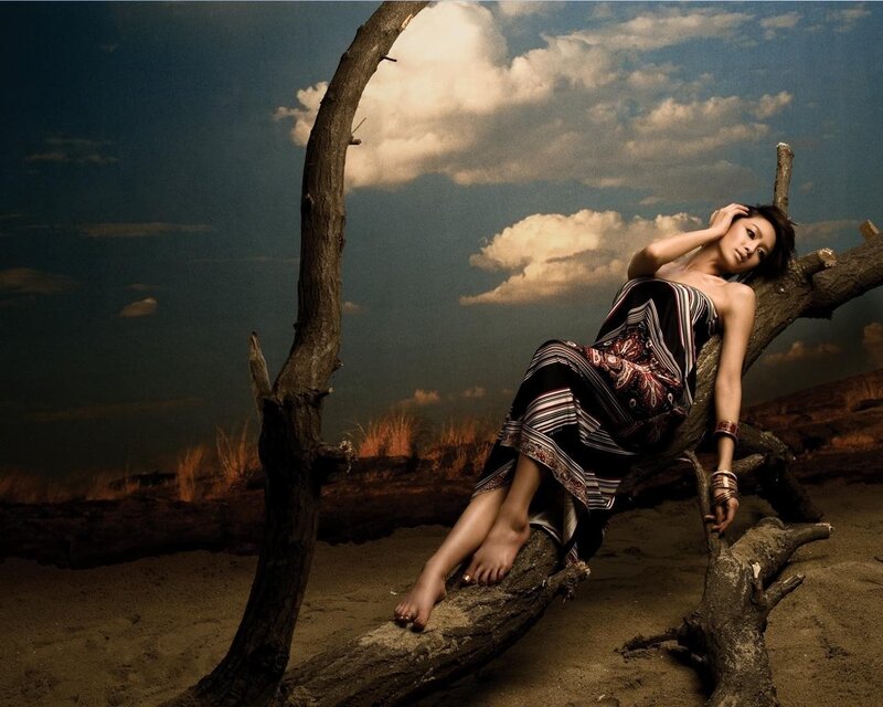 Woman resting on driftwood