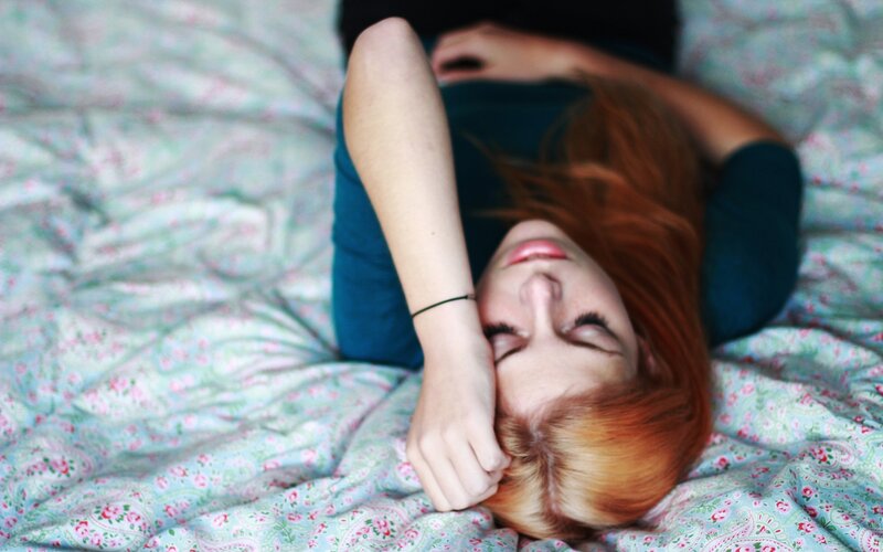 woman resting on floral bed