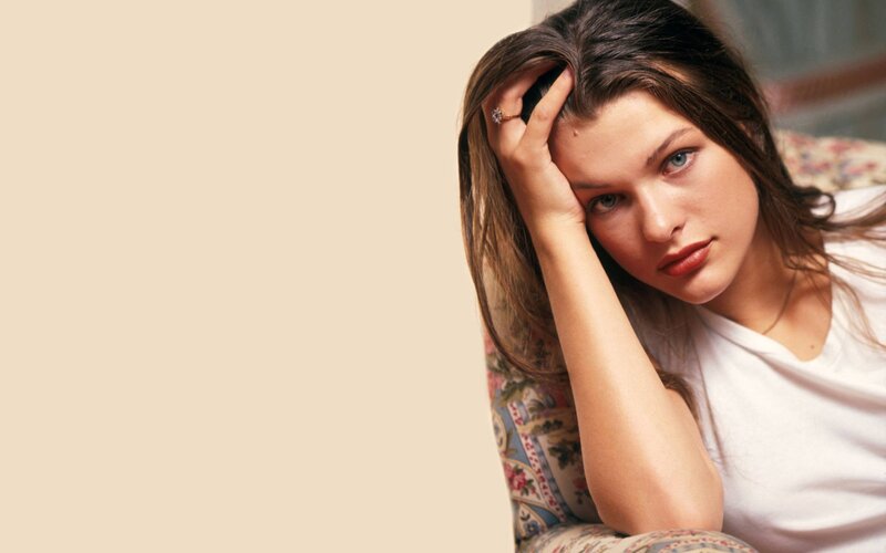 woman resting on floral couch