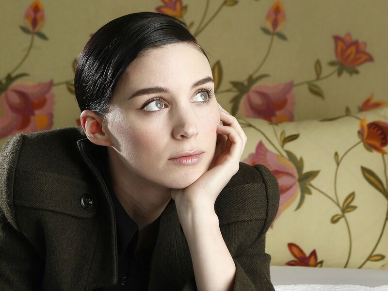 woman resting on floral couch