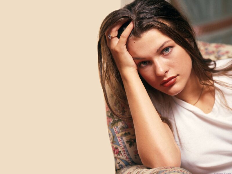 woman resting on floral couch