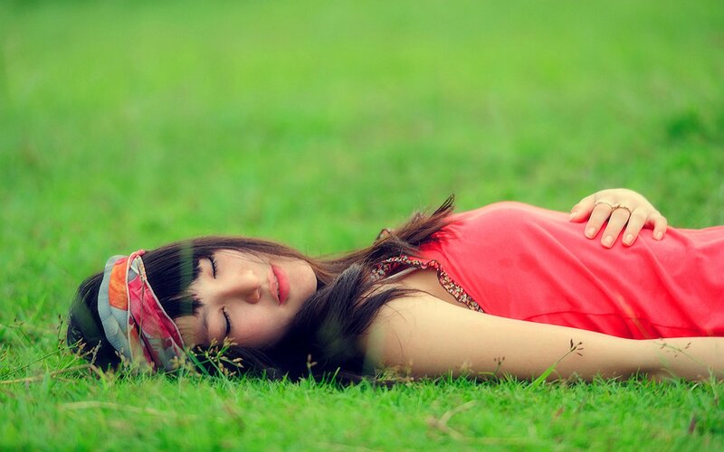 woman resting on grass