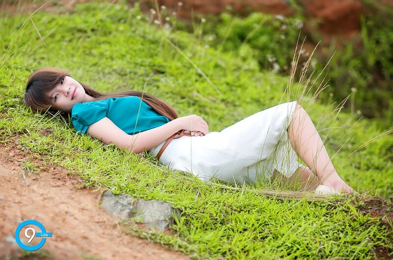 Woman resting on grassy hill